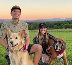 Representatives of Foolhardy Hill with their dogs in a field